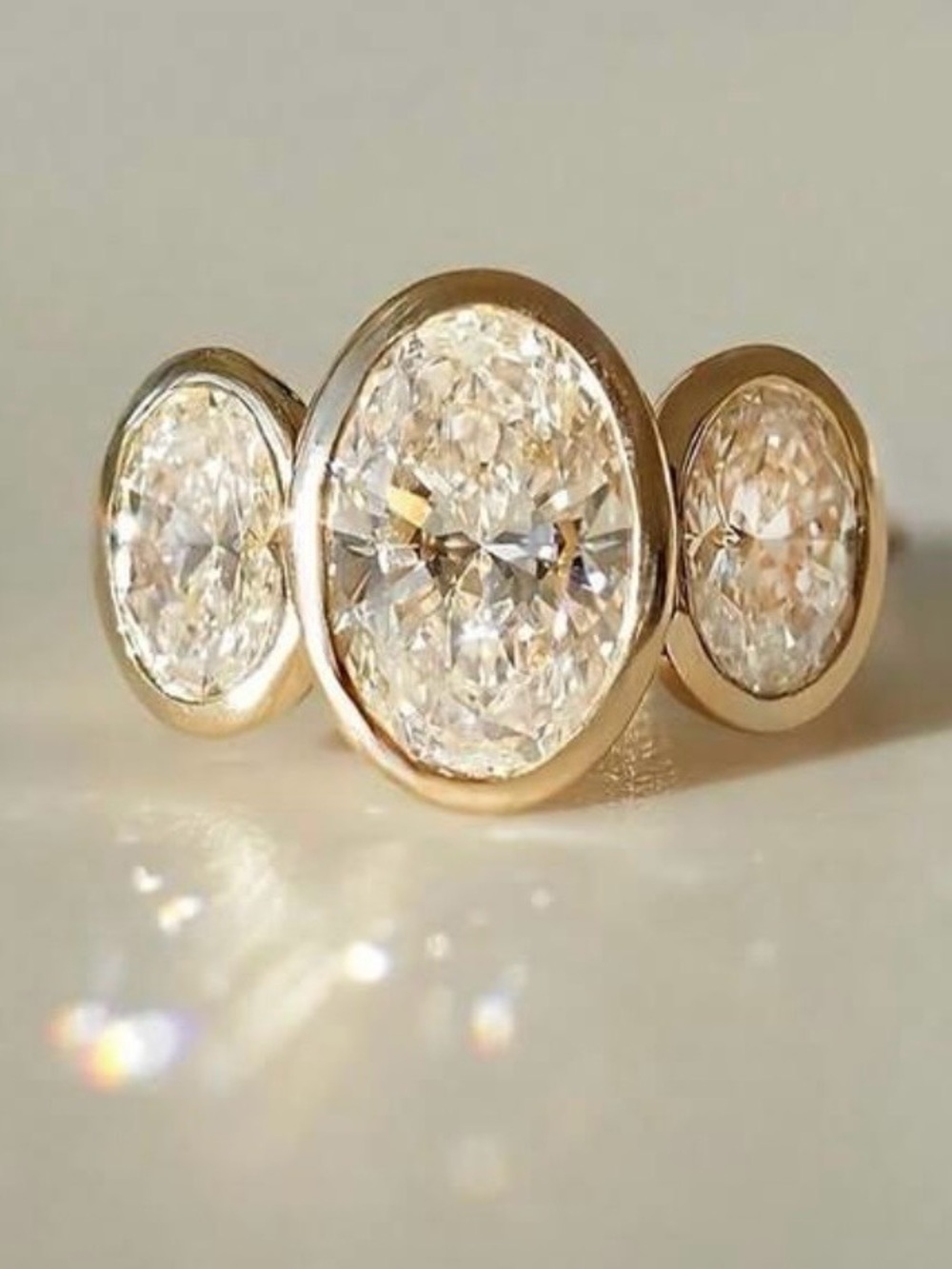 Stunning Three-Stone Oval CZ Ring in Yellow Gold